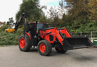 Red Mower with trees in the background