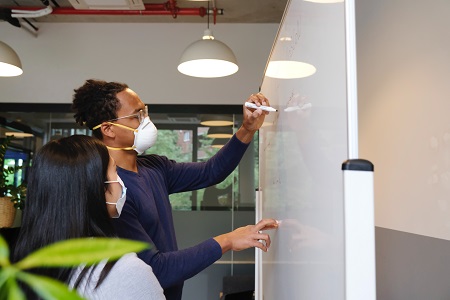 Person writes on whiteboard