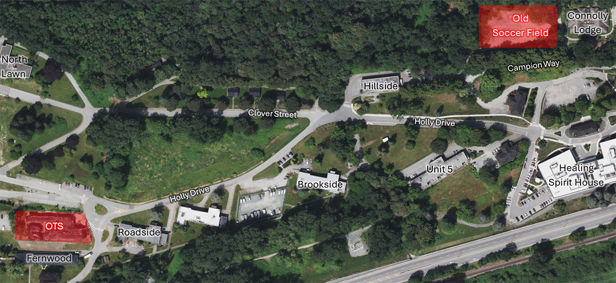 An aerial view of an area showing a storage location labeled 'Storage Location (Old Transportation Station)' situated between Holly Drive and Clover Street, with nearby buildings, parking lots, and surrounding greenery.